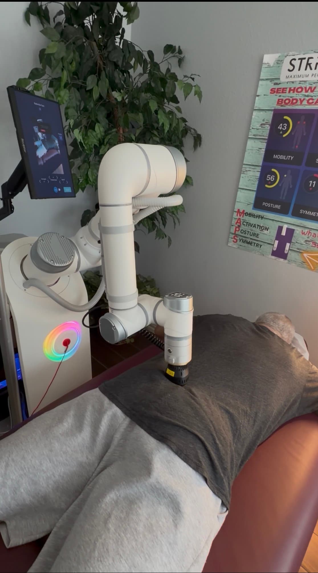 A client lying face down while the AI Robot Massage works along the back